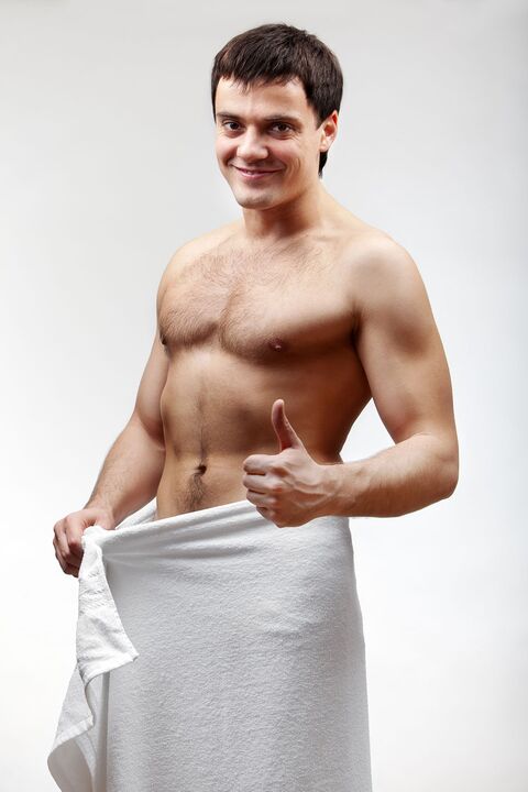 man in towel is pleased with the increase in the size of his penis