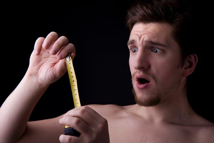 a man with a measuring tape measured his penis before enlargement surgery